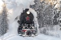 Old Soviet steam locomotive L-5031 in a snowy forest on a January day