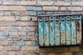 Old Soviet-style mailboxes. Old metal and numbered mailboxes on brick wall Royalty Free Stock Photo