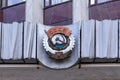 Old Soviet symbols, coat of arms of the USSR, red flag and star on old facade