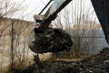 An old Soviet tractor digs and loads waste stone processing Royalty Free Stock Photo