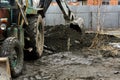 An old Soviet tractor digs and loads waste stone processing Royalty Free Stock Photo