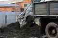 An old Soviet tractor digs and loads waste stone processing Royalty Free Stock Photo