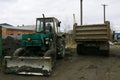 An old Soviet tractor digs and loads waste stone processing Royalty Free Stock Photo