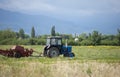 An old soviet tractor working in a field in Kyrgyzstan Royalty Free Stock Photo