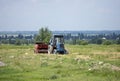 An old soviet tractor working in a field in Kyrgyzstan Royalty Free Stock Photo