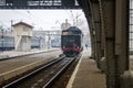 Old Soviet vintage black retro train with a red star at the railway station in Lviv produces steam from the pipes and the passeng Royalty Free Stock Photo