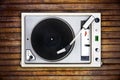 The old Soviet vinyl player isolated on wooden background.