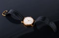 Old soviet wristwatch on black glossy background Royalty Free Stock Photo