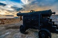 Old Spanish Cannon on the carriage in San Pedro de La Roca fort walls, with Caribbean sea sunset view, Santiago De Cuba, Cuba