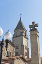 An old Spanish Catholic church with a dome and a cross with a bell