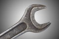 Old spanner on grey background Royalty Free Stock Photo
