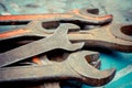 Old spanners. Grunge background of instruments. Keys close-up. Vintage turquoise and red Royalty Free Stock Photo