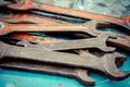 Old spanners. Grunge background of instruments. Keys close-up. Vintage turquoise and red Royalty Free Stock Photo