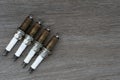 Old spark plugs on the wooden table background Royalty Free Stock Photo