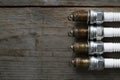 Old spark plugs on the wooden table Royalty Free Stock Photo