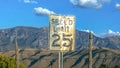 Old speed limit sign against mountain and sky Royalty Free Stock Photo