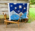 An old spinning wheel and a quilt on display at an historic site in virginia Royalty Free Stock Photo