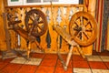 Old spinning wheel on wooden