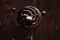 Old spiral door iron metal handle to a haunted house close up Royalty Free Stock Photo