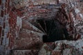 Old spiral staircase inside red brick tower, upside view Royalty Free Stock Photo