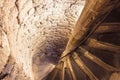 Old spiral staircase made with stone and with metal railing Royalty Free Stock Photo