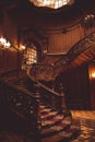 Old spiral wooden staircase with vintage railing indoors. luxury carved wood interior in the hall of an aristocratic palace. rare Royalty Free Stock Photo