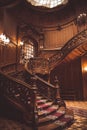 Old spiral wooden staircase with vintage railing indoors. luxury carved wood interior in the hall of an aristocratic palace. rare Royalty Free Stock Photo