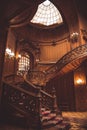 Old spiral wooden staircase with vintage railing indoors. luxury carved wood interior in the hall of an aristocratic palace. rare Royalty Free Stock Photo