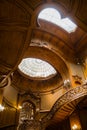 Old spiral wooden staircase with vintage railing indoors. luxury carved wood interior in the hall of an aristocratic palace. rare Royalty Free Stock Photo