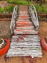 Old spoiled wooden footbridge. Small bridge in rural garden. Asian, oriental and Vietnamese culture Royalty Free Stock Photo