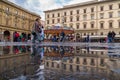 Old square in Florence with carousel and people and tourists haveing fun reflections in puddle Royalty Free Stock Photo