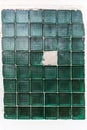 Old square glass blocks wall. One block broken and sealed with cement Royalty Free Stock Photo