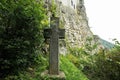 Old srone croos against Bran Castle in Romania. Dracula medieval castle in Carpathians, Transylvania