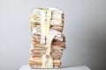 Old stack of waste paper and a roll of toilet paper Royalty Free Stock Photo