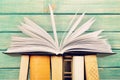 Old stacked books on table background