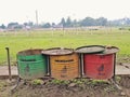 Old stain rubbish bin or trash can for organic anorganic trash in public space near grass field of horse racing track or site Royalty Free Stock Photo