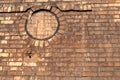 Old stained brick wall of an industrial building, round porthole window bricked in, creative copy space Royalty Free Stock Photo