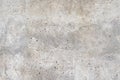 Old stained concrete wall with multi-colored pebble stones. Texture of gray color cement background, dry scratched surface wall Royalty Free Stock Photo