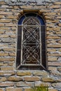 Old stained glass on the apparent brick wall Royalty Free Stock Photo