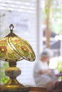 The Old Stained Glass Tiffany table Lamp with blurred vertical background of Vintage coffee shop