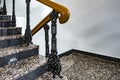 Old staircase in the stairwell with wooden railing and wrought-iron lattice Royalty Free Stock Photo