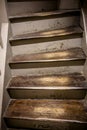 Old staircase with wooden steps worn out from long use