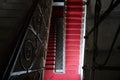 Old stairs in the historical palace. Classic stairways with red carpet.