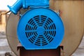 Old stationary engine cleaned and painted blue. engine exhaust system.