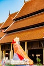 Old statue with ancient church of Prathat Lampang Luang temple