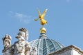 Old statue of a golden angel as a warrior and defender at the dome top of the central historical building Zitronenpresse in Royalty Free Stock Photo