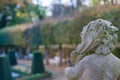 Stone angel statue in garden. Guardian angel statue in sunlight as a symbol of love in garden. Royalty Free Stock Photo