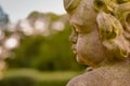 Stone angel statue in garden. Guardian angel statue in sunlight as a symbol of love in garden. Royalty Free Stock Photo