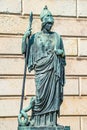 Old Statue Of A Roman Armed Soldier With Spear And Helmet, And A Snake At His Foot In Potsdam, A German Town Of Statues And