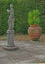 An old statue and vase in a country garden